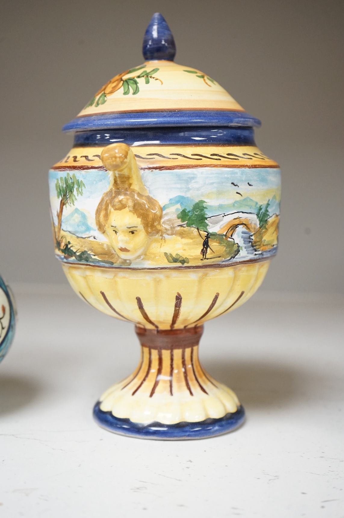 A pair of Isnik pottery vases and majolica vase and cover, largest 22cm high. Condition - fair, some restoration